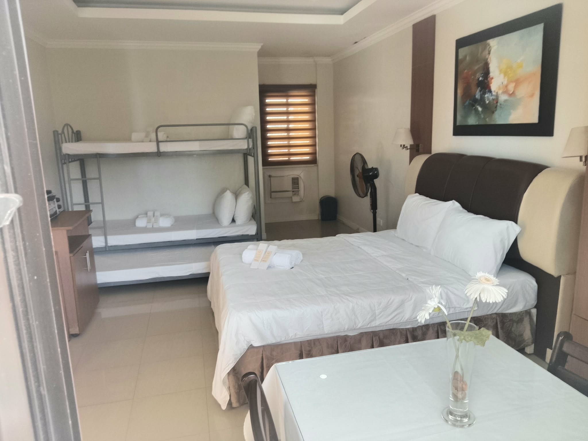 Guest room with a queen bed and bunk bed